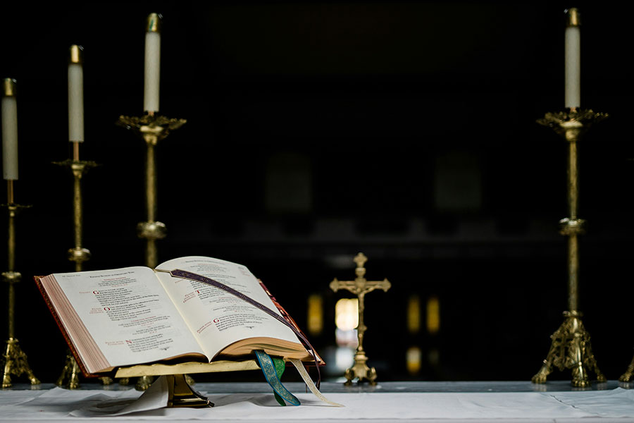 Un libro liturgico encima de un altar con candelas